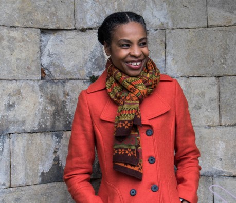 Smiling woman in a red coat and scarf